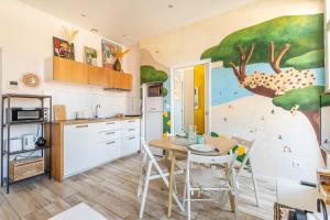 a kitchen with a table and chairs in a room at T2 avec balcon à Malmousque - Calme & vue mer in Marseille