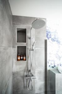 a bathroom with a shower with a glass door at Apartman Margareta in Matulji