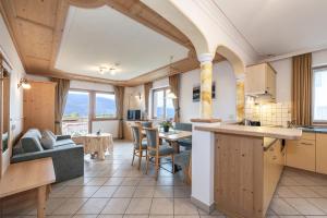 a kitchen and living room with a table and chairs at Residence Diana Apartment 303 in Terento