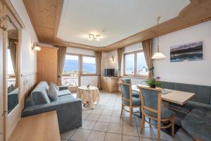 a living room with a couch and a table at Residence Diana Apartment 303 in Terento