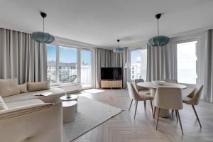 a living room with a couch and a table at Przystań Letnica Seaside by Downtown Apartments in Gdańsk +46 photos