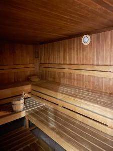 a sauna with wooden benches and a clock on the wall at Casa Alpina Top 33 in Saalbach Hinterglemm +16 photos