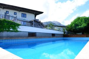a swimming pool in front of a building at Appartements Hitzenbichler in Abtenau