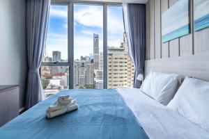 Ένα ή περισσότερα κρεβάτια σε δωμάτιο στο Hyde Sukhumvit 11 Branded Suites