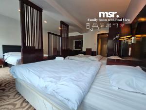A bed or beds in a room at Kota Kinabalu City Ensuite at SCSP Ming Garden