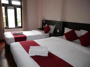 Llit o llits en una habitació de Hotel Nevis
