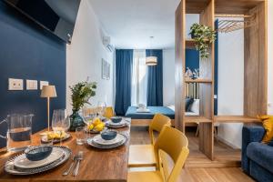 a dining room with a table and a living room at Taro's Blue Sea Apartment by Pleiades Home in Marina di Pisa