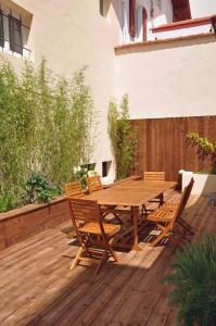 a wooden table and chairs on a wooden deck at Appartement Terrasse Plage in Biarritz