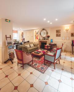 a living room filled with furniture and a fireplace at Le Relais Montmartre in Paris