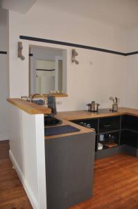 a kitchen with a sink and a counter top at Appartement Terrasse Plage in Biarritz +11 photos