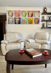 a living room with two couches and a coffee table at Algirdo Apartments, Self Check-in, Free Private Parking in Vilnius