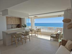 a kitchen and living room with a view of the ocean at eme de Maison - luxury only two in Arenales del Sol