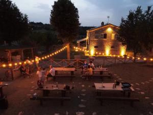 a group of people sitting at tables in front of a building at Casa Addis B&B in Scapezzano