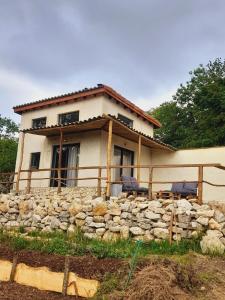 a house with a stone wall in front of it at Cozy Tiny House plus SPA - à Pereille d'en Haut in Péreille +9 photos
