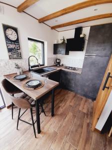 a kitchen with a wooden table and a sink at Cozy Tiny House plus SPA - à Pereille d'en Haut in Péreille