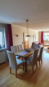 a dining table and chairs in a living room at Ferienwohnung Am Gillrather Hof in Geilenkirchen