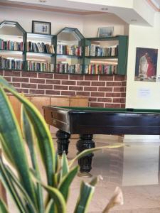 a library with a table in front of a book shelf at Miray Hotel Kleopatra in Alanya +37 photos