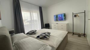 a bedroom with a bed with two pillows on it at Apartament Ovy Residence Râșnov in Râşnov