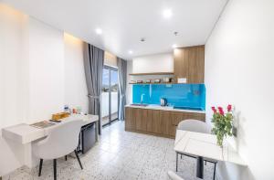 a kitchen with a white and blue kitchen at Green LP Hotel & Apartment in Vung Tau +46 photos