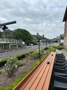 a wooden bench sitting on the side of a street at Radisson Blu Hotel, Durham in Durham