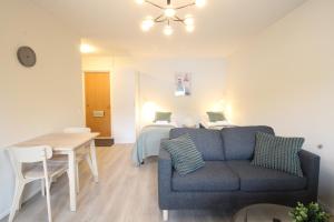 a living room with a couch and a bedroom at Forenom Serviced Apartments Hämeenlinna Katuma 8 in Hämeenlinna +65 photos
