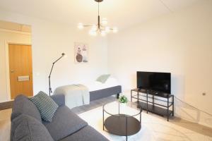 a living room with a couch and a bed at Forenom Serviced Apartments Hämeenlinna Katuma 8 in Hämeenlinna