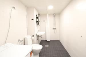 a bathroom with a toilet and a sink at Forenom Serviced Apartments Hämeenlinna Katuma 8 in Hämeenlinna