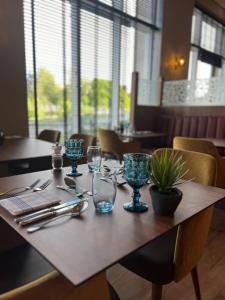 a wooden table with glasses and utensils on it at Radisson Blu Hotel, Durham in Durham