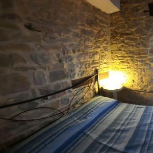 a bed in a room with a stone wall at Antiqua in Sestino +30 photos