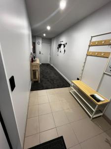 a hallway with a room with white walls and a shelf at 379 on Kāpiti in Paraparaumu
