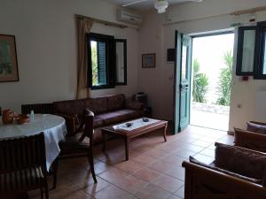 a living room with a couch and a table at Vatoulia House in Neo Itilo