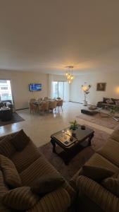 a living room with a couch and a table at Appartement spacieux - BD Anfa in Casablanca