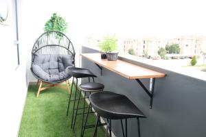 a table and chairs on a balcony with grass at Blessing Suite- Serenity and Stuff Luxury Apartments in Midrand