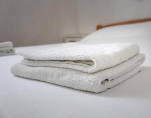 a stack of white towels sitting on top of a counter at Kornati Paradise Residence Slanica in Murter +24 photos