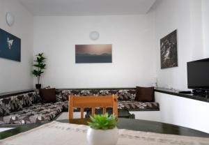 a living room with a couch and a table at Kornati Paradise Residence Slanica in Murter