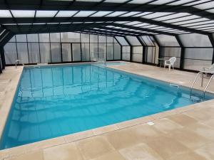 a large swimming pool with blue water at Arriu Mage 105 in Bielle