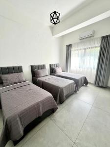 a bedroom with two beds and a window at Jordan Tower Hotel in Amman
