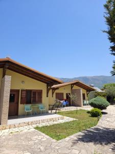 a house with a patio in front of it at Resort Te Zagolli in Orikum
