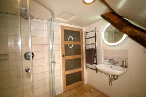 een badkamer met een wastafel en een douche bij Putsborough Manor 3 Self Catering Cottages with Beach a short walk, dog friendly all year, On site Tennis, Play Area, Paddock, Spa baths, BBQ, Private Gardens, Superfast WIFI in Croyde +55 foto's
