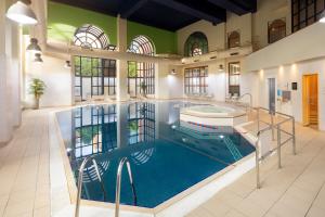 a large swimming pool in a large room with a pool at Crowne Plaza Leeds by IHG in Leeds