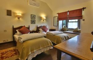 A bed or beds in a room at The Himalayan