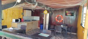 a restaurant with a kitchen and a table and chairs at REMINA in Sulina