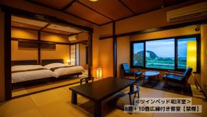 A bed or beds in a room at Omoideno Jinde