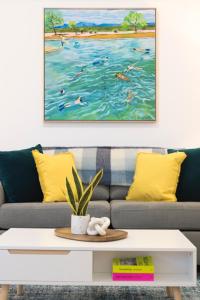 a painting of people swimming in the ocean at Charming One-Bedroom Apartment in Northbridge in Perth