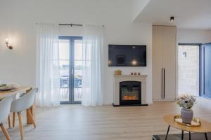 a living room with a fireplace and a tv at Luxury Villa Oliva Oliana heated pool 32m2 in Vrsi