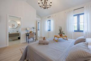 a white bedroom with a large bed and a bathroom at Luxury Villa Oliva Oliana heated pool 32m2 in Vrsi +53 photos