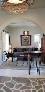 a living room with a couch and a table at Pleiades Modern Villa with Shared Pool in Ornos in Ornos