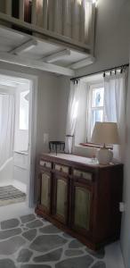 a room with a table with a lamp and a window at Pleiades Modern Villa with Shared Pool in Ornos in Ornos