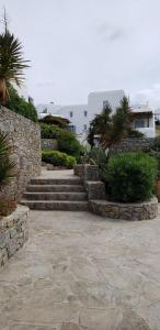 a set of stone steps leading up to a building at Pleiades Modern Villa with Shared Pool in Ornos in Ornos