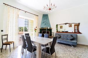 a dining room with a table and a couch at Casa Venere Luxury Apartment in Giuggianello